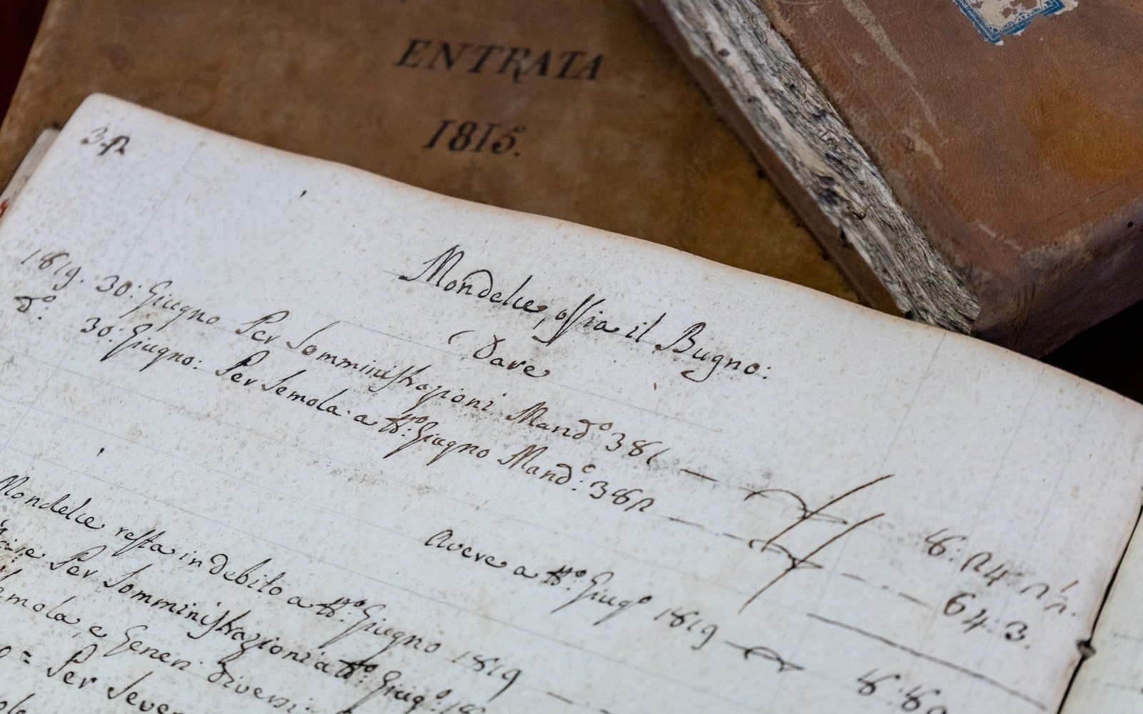 A ledger page open with a hand steadying it