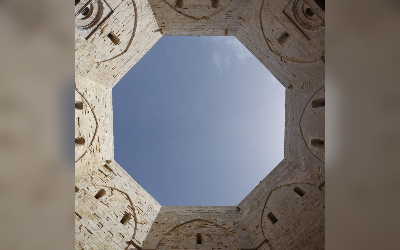 Looking straight up through Castel del Monte's octagonal courtyard toward the sky