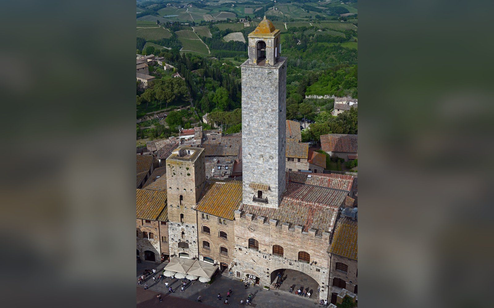 A hill town's towers against flat sky